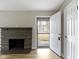 The living room has a fireplace, and new floors, freshly painted with view of front yard at 305 Bixler Rd, Indianapolis, IN 46227