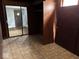 Compact bedroom with wood paneling, closet, and functional layout at 317 S Harris Ave, Indianapolis, IN 46222