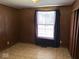 Functional bedroom space with wood paneling, closet, and natural light at 317 S Harris Ave, Indianapolis, IN 46222