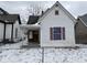 Quaint single-Gathering home with a snow-covered yard and classic architectural details at 317 S Harris Ave, Indianapolis, IN 46222