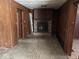 Spacious living room featuring a brick fireplace, paneled walls, and vintage charm at 317 S Harris Ave, Indianapolis, IN 46222