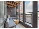 This condo features a cozy, covered balcony with outdoor seating and a modern design at 319 E 16Th St # 203, Indianapolis, IN 46202