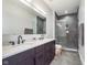 Modern bathroom featuring double sinks, elegant vanity, and walk-in shower with glass enclosure at 319 E 16Th St # 203, Indianapolis, IN 46202