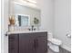 Modern bathroom featuring a dark wood vanity with light countertop and decorative accents at 319 E 16Th St # 203, Indianapolis, IN 46202