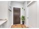 Inviting entryway with hardwood floors, coat rack, and decorative plants at 319 E 16Th St # 203, Indianapolis, IN 46202