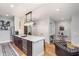 Bright kitchen with stainless steel appliances, a spacious island with a white countertop, and wood flooring at 319 E 16Th St # 203, Indianapolis, IN 46202