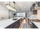 Contemporary kitchen with a view into the living room featuring a stainless steel range and elegant pendant lighting at 319 E 16Th St # 203, Indianapolis, IN 46202