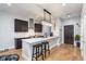 Kitchen featuring a stylish island with bar seating and modern appliances under recessed lighting and wood floors at 319 E 16Th St # 203, Indianapolis, IN 46202