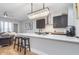 Modern kitchen with crystal pendant lighting, stainless steel appliances, and breakfast bar at 319 E 16Th St # 203, Indianapolis, IN 46202