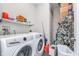 Well-equipped laundry room with modern washer and dryer, plus shelving for storage at 319 E 16Th St # 203, Indianapolis, IN 46202