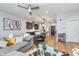 Open-concept living area with a view of the kitchen, featuring wood floors and a comfortable seating arrangement at 319 E 16Th St # 203, Indianapolis, IN 46202