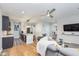 Open-concept living area with a view of the kitchen, featuring wood floors and a comfortable seating arrangement at 319 E 16Th St # 203, Indianapolis, IN 46202