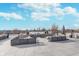 Rooftop patio with gray lounge seating, planters, and downtown skyline view at 319 E 16Th St # 203, Indianapolis, IN 46202