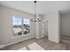 Bright dining room with wood floors, a chandelier, and a large window at 4150 Douro Trl, Westfield, IN 46062
