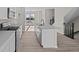 Modern kitchen featuring an island with a sink, white cabinets, and stainless steel appliances at 4150 Douro Trl, Westfield, IN 46062