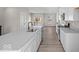 Bright, modern kitchen featuring white cabinetry, stainless steel appliances, and an island sink at 4150 Douro Trl, Westfield, IN 46062