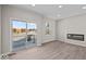 Spacious living room with wood floors, fireplace, and sliding glass doors leading to a balcony at 4150 Douro Trl, Westfield, IN 46062