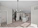 Open concept living space featuring a chandelier, stairs, and kitchen in the background at 4150 Douro Trl, Westfield, IN 46062