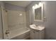 Well-lit bathroom with tub-shower, vanity, and classic fixtures at 428 Cleveland St, Columbus, IN 47201