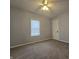 Comfortable bedroom with plush carpeting, a ceiling fan, and a bright window at 428 Cleveland St, Columbus, IN 47201