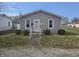 Charming single-story home with light grey siding, manicured lawn, and a welcoming front entrance at 428 Cleveland St, Columbus, IN 47201