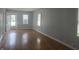 Open living room with hardwood floors, two windows, and an inviting front door view at 428 Cleveland St, Columbus, IN 47201