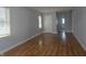 Bright living room with gleaming hardwood floors, white trim and fresh light-grey paint at 428 Cleveland St, Columbus, IN 47201