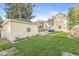 Backyard view with a lush green lawn and detached garage, offering a private outdoor space and additional parking at 4305 Central Ave, Indianapolis, IN 46205