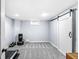 Finished basement area featuring a gym area, a white sliding barn door, and neutral walls at 4305 Central Ave, Indianapolis, IN 46205