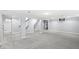 Large finished basement area with neutral carpeting and exposed support pillars at 4305 Central Ave, Indianapolis, IN 46205