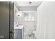 This traditional bathroom features a tiled shower, vanity, and a window at 4305 Central Ave, Indianapolis, IN 46205