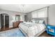 This spacious bedroom features hardwood floors, area rug, chandelier and an upholstered bed at 4305 Central Ave, Indianapolis, IN 46205