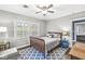 Cozy bedroom with an area rug, hardwood floors, and natural light from the windows at 4305 Central Ave, Indianapolis, IN 46205