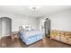 Bedroom featuring hardwood floors, overhead lighting and a view of the hallway at 4305 Central Ave, Indianapolis, IN 46205
