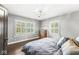 Charming bedroom with natural light, hardwood floors, and a view of the wooded yard at 4305 Central Ave, Indianapolis, IN 46205