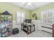 Well-lit bedroom with a work desk, built-in shelving, and paneled walls at 4305 Central Ave, Indianapolis, IN 46205