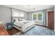 Cozy bedroom featuring an upholstered bed, area rug, and natural light from the window at 4305 Central Ave, Indianapolis, IN 46205