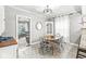 Open-concept dining area featuring a round wooden table and view into the living room at 4305 Central Ave, Indianapolis, IN 46205