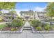 Traditional home with a well-manicured lawn, complemented by lush landscaping and a welcoming walkway to the front door at 4305 Central Ave, Indianapolis, IN 46205