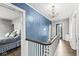 Bright hallway features hardwood floors, and a charming chandelier lighting the stairway at 4305 Central Ave, Indianapolis, IN 46205