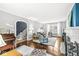 Cozy living room with hardwood floors, a fireplace, piano, and comfortable seating arrangement at 4305 Central Ave, Indianapolis, IN 46205