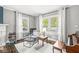 Comfortable sitting area filled with natural light and hardwood floors, perfect for relaxation and reading at 4305 Central Ave, Indianapolis, IN 46205