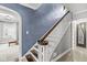 Detailed staircase with hardwood treads, white risers, and a decorative banister, next to archway at 4305 Central Ave, Indianapolis, IN 46205