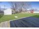 A large, green backyard with a shed, lawn, and a wooden deck at 4623 Clark St, Anderson, IN 46013