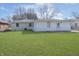 A spacious backyard featuring lawn and an entrance door at 4623 Clark St, Anderson, IN 46013