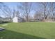 This backyard features a lush lawn and a storage shed at 4623 Clark St, Anderson, IN 46013