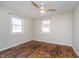 This bedroom features wood-look flooring, a ceiling fan, and two large windows at 4623 Clark St, Anderson, IN 46013