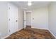 This bedroom features wood-look flooring, a ceiling fan, and access to another room at 4623 Clark St, Anderson, IN 46013