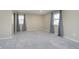 This carpeted bedroom features two large windows and neutral wall color at 4623 Clark St, Anderson, IN 46013