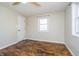 This bedroom features wood-look flooring, a ceiling fan, and a large window at 4623 Clark St, Anderson, IN 46013